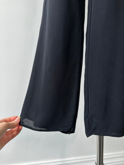 Vintage 1990s pure silk wide-leg trousers in size W30, showcasing flowing fabric and classic high-waisted design.