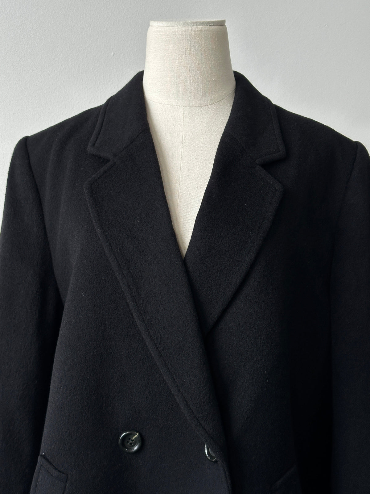 Vintage 1990s pure cashmere double-breasted coat in classic style, shown in beige with wide lapels and button details.