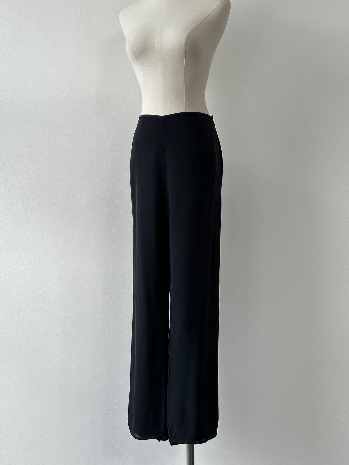 Vintage 1990s pure silk wide leg trousers in size W30, showcasing smooth fabric and classic high-waisted fit.