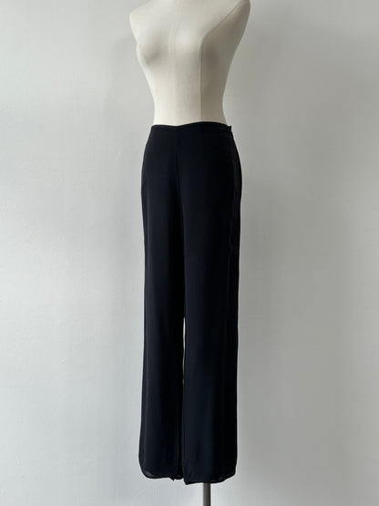 Vintage 1990s pure silk wide leg trousers in size W30, showcasing smooth fabric and classic high-waisted fit.