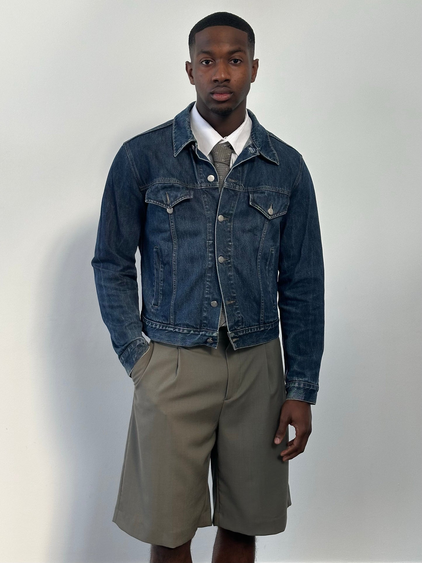 Armani Jeans 1990s pure cotton denim jacket with classic fit, button closure, and chest pockets, displayed on a hanger.