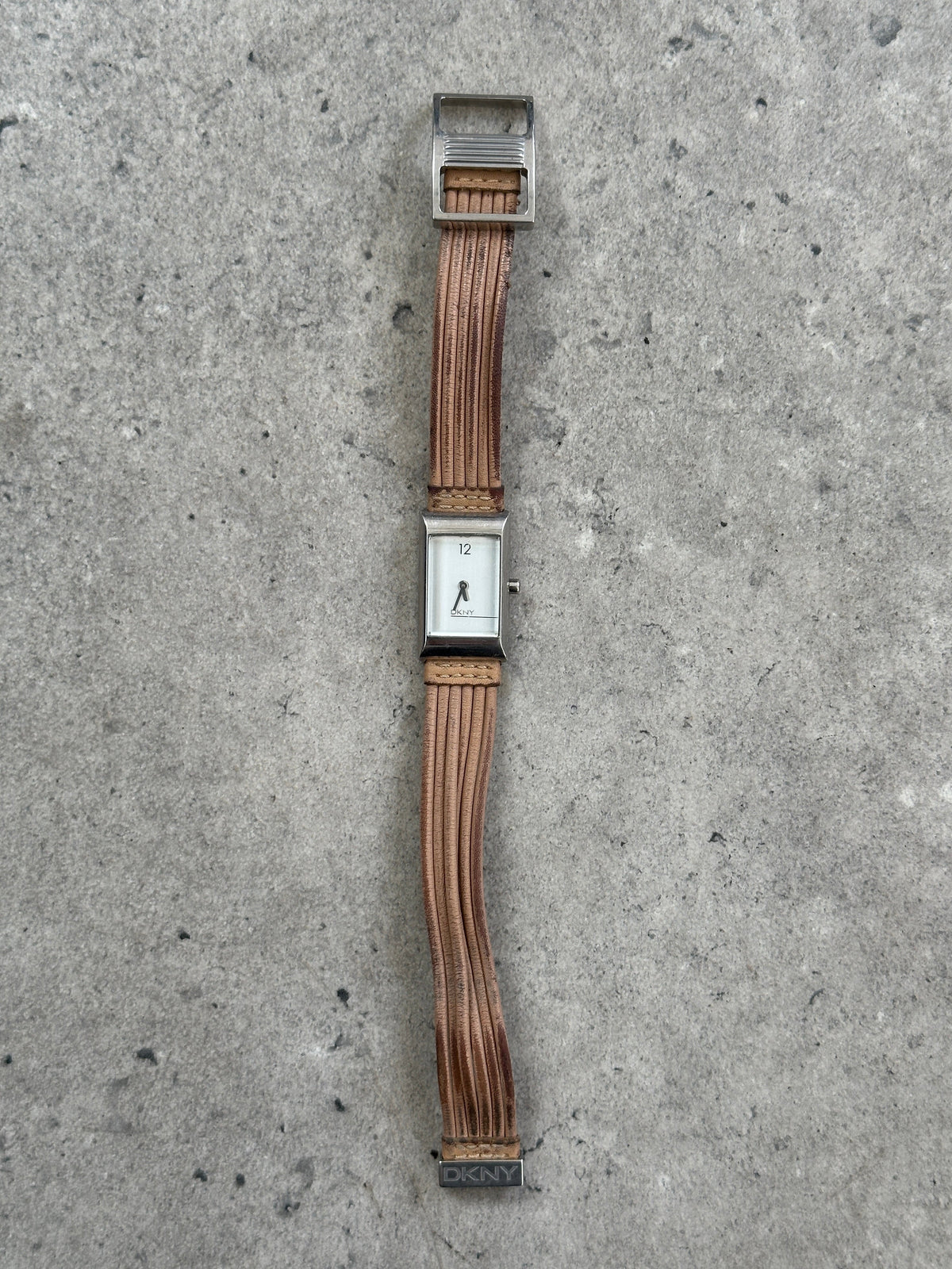 Donna Karran DKNY 2000s leather rectangular quartz watch with a sleek black leather strap and silver-tone rectangular face.