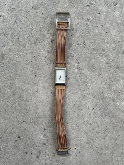 Donna Karran DKNY 2000s leather rectangular quartz watch with a sleek black leather strap and silver-tone rectangular face.