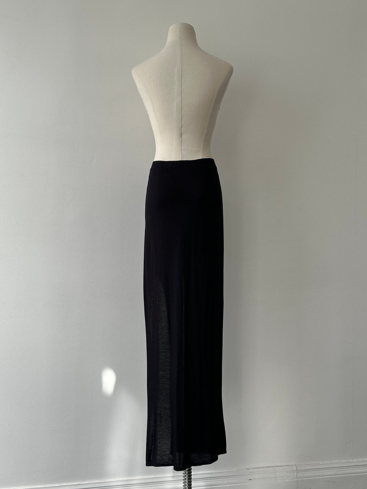 Helmut Lang 2000s side split maxi skirt in black, flowy fabric with high waist and dramatic side slit, stylish and modern.