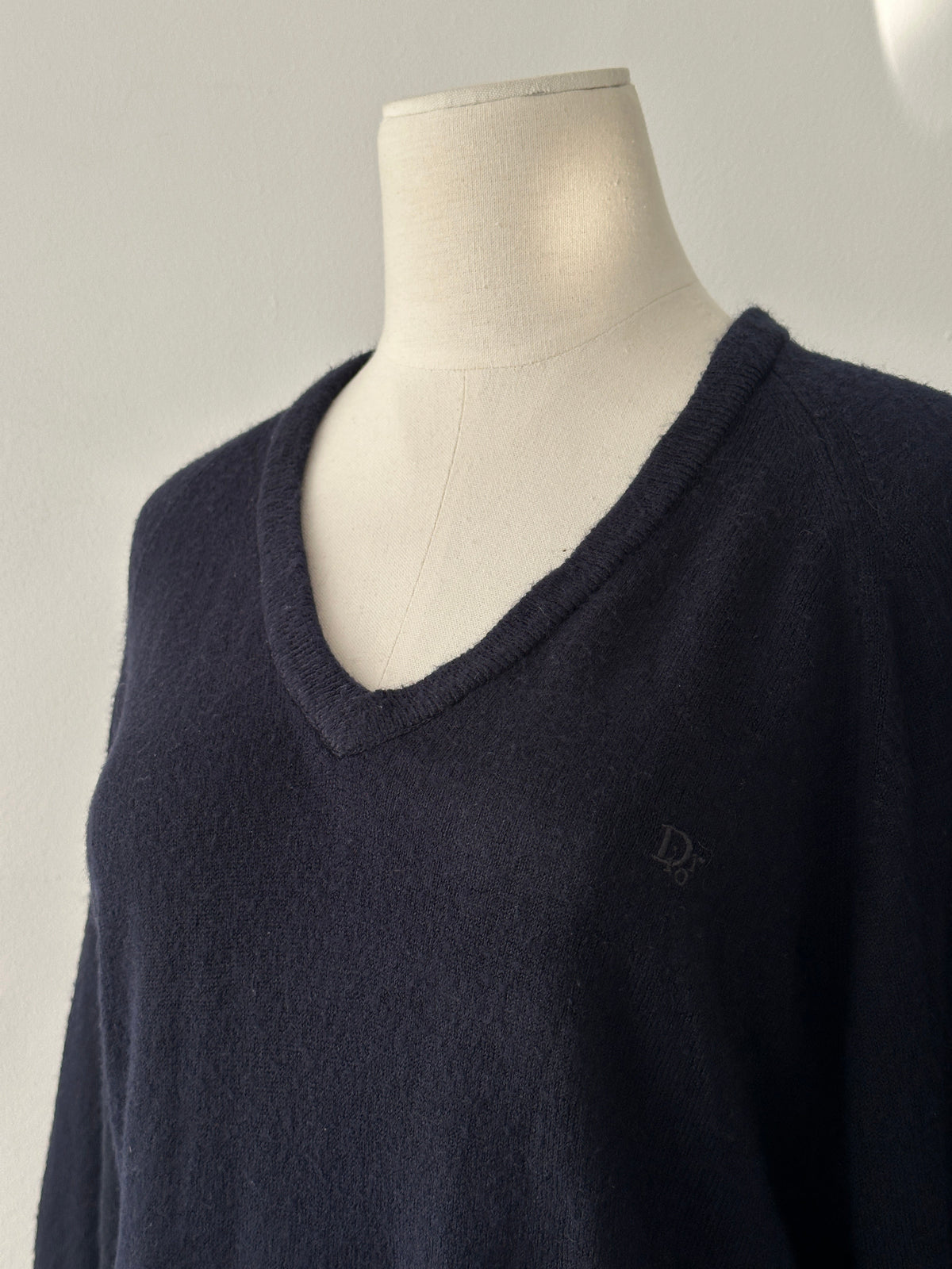 Christian Dior 1990s V-neck logo jumper in black, featuring Dior branding and a classic fit, displayed on a mannequin.