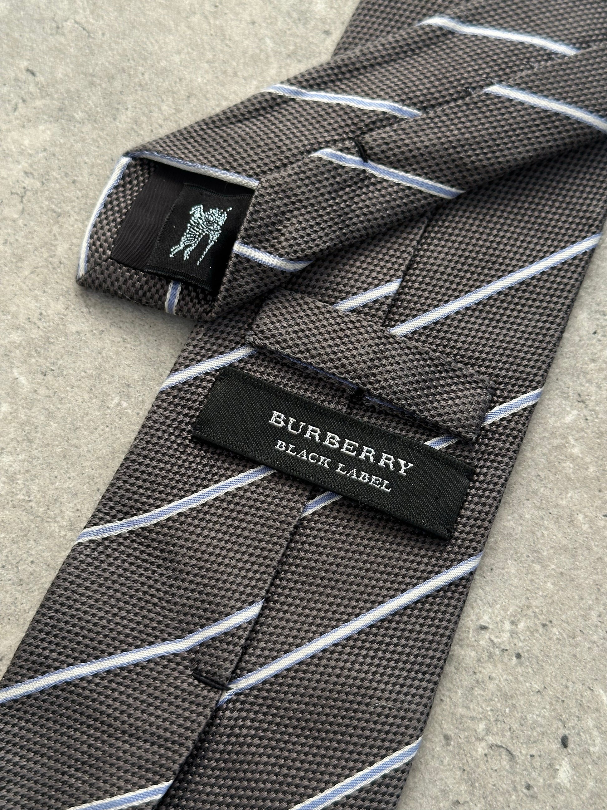 Burberry Black Label 2000s pure silk striped tie with classic pattern, shown laid flat with detailed fabric texture.