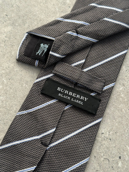 Burberry Black Label 2000s pure silk striped tie with classic pattern, shown laid flat with detailed fabric texture.