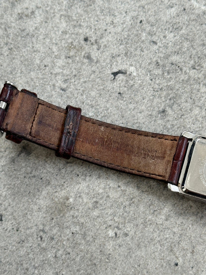 Emporio Armani 2000s leather rectangular quartz watch with a sleek design and silver-tone dial, displayed on a white background.