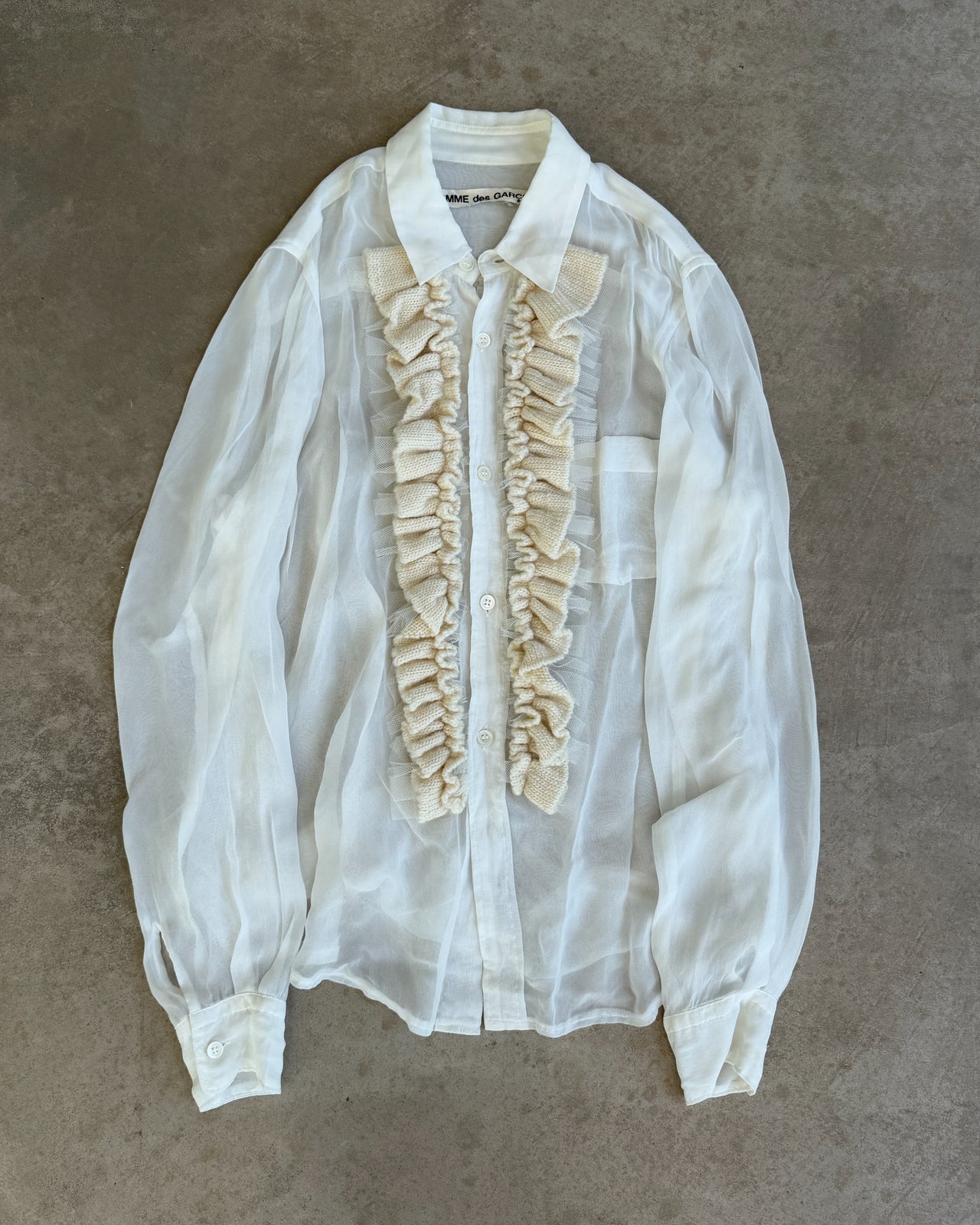 Comme des Garçons Sheer White Shirt-on a concrete background