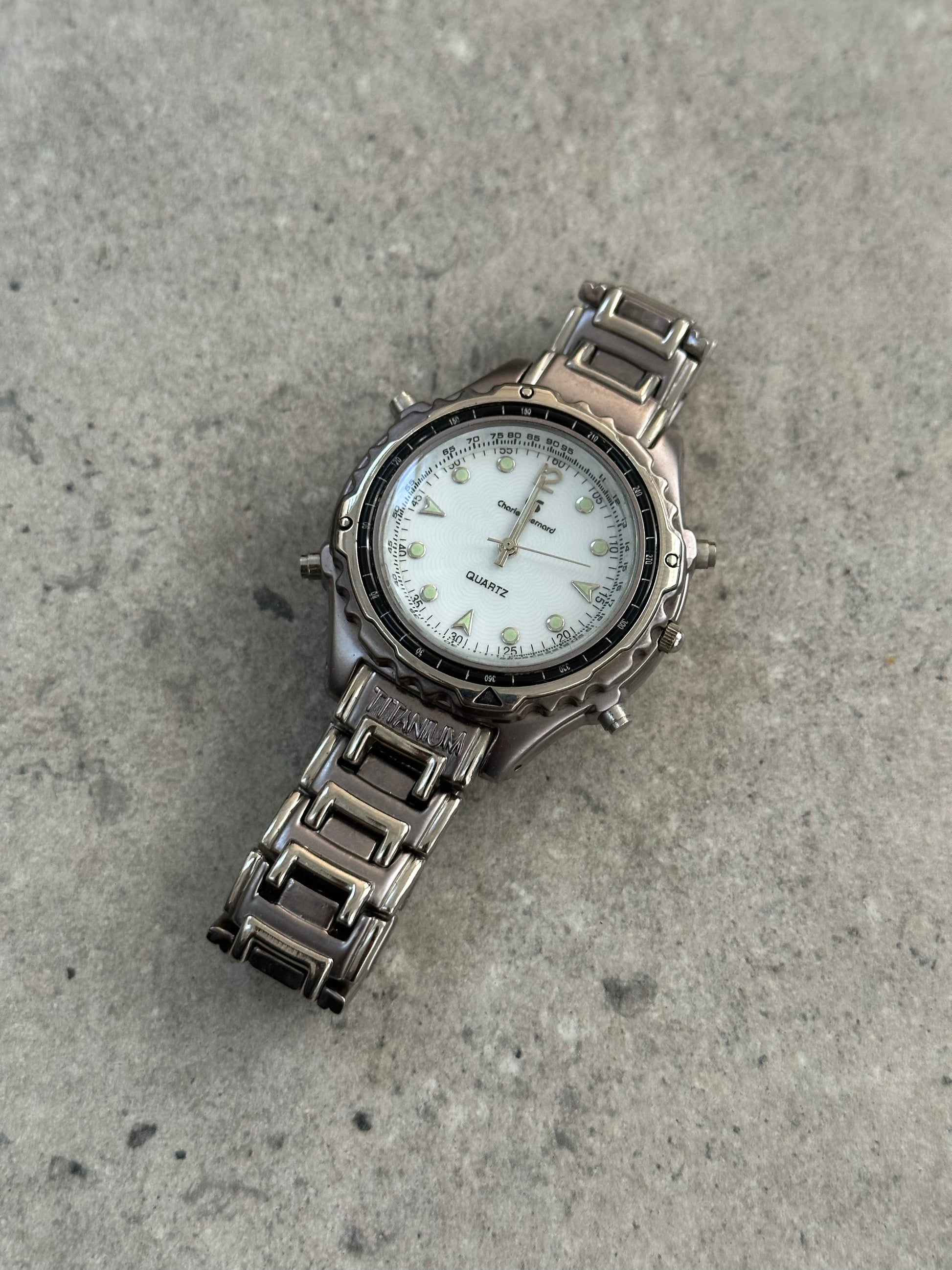 Vintage 1990s Titanium Quartz Sports Watch with black dial, stainless steel case, and sporty design.