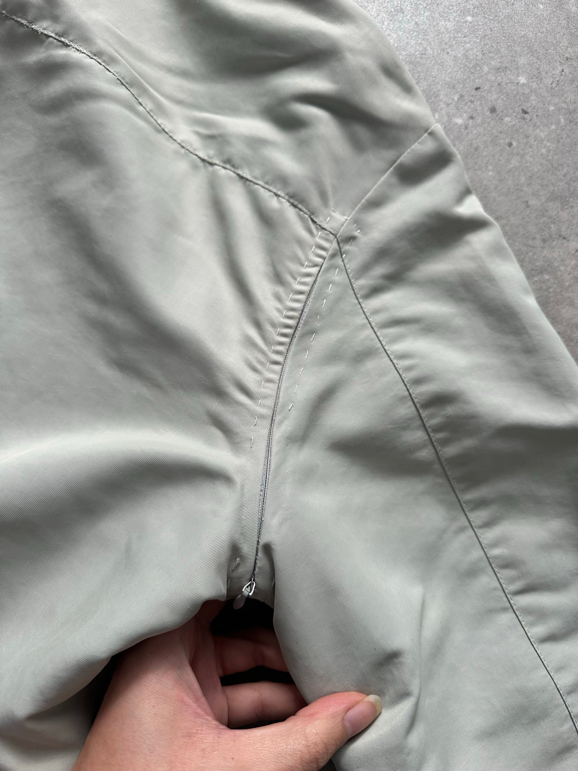 Gianfranco Ferre 1990s showerproof minimal jacket in size L, shown in a sleek, lightweight design with a neutral color.