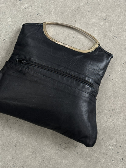 Vintage 1990s leather handbag with classic design, featuring a structured shape and aged leather finish.