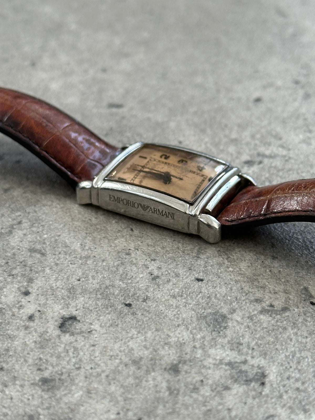 Emporio Armani 2000s leather rectangular quartz watch with a classic design, black leather strap, and silver-tone dial.