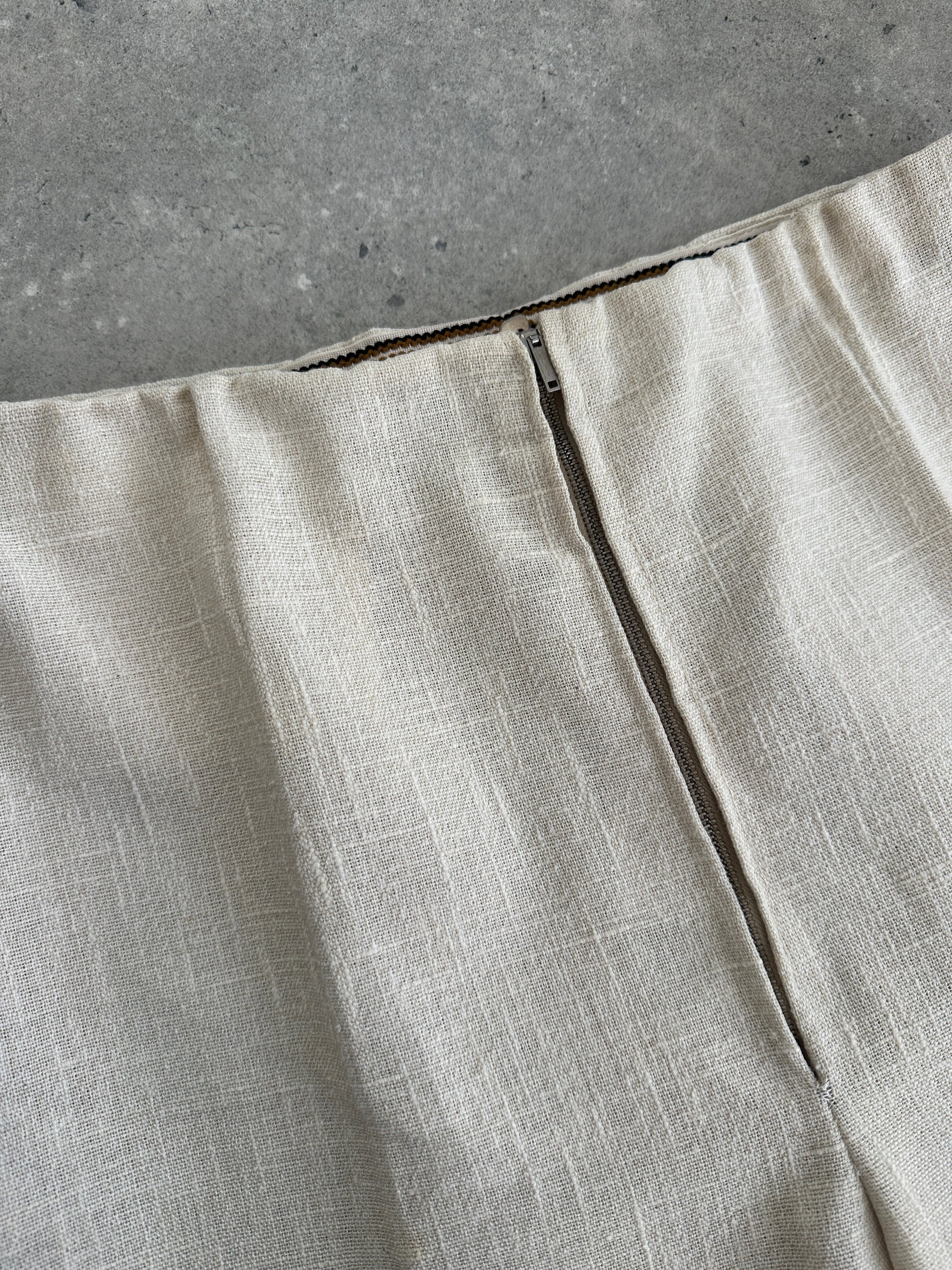 Vintage 1990s linen high waist cropped trousers with wide leg fit, light beige color, and vintage branding details.