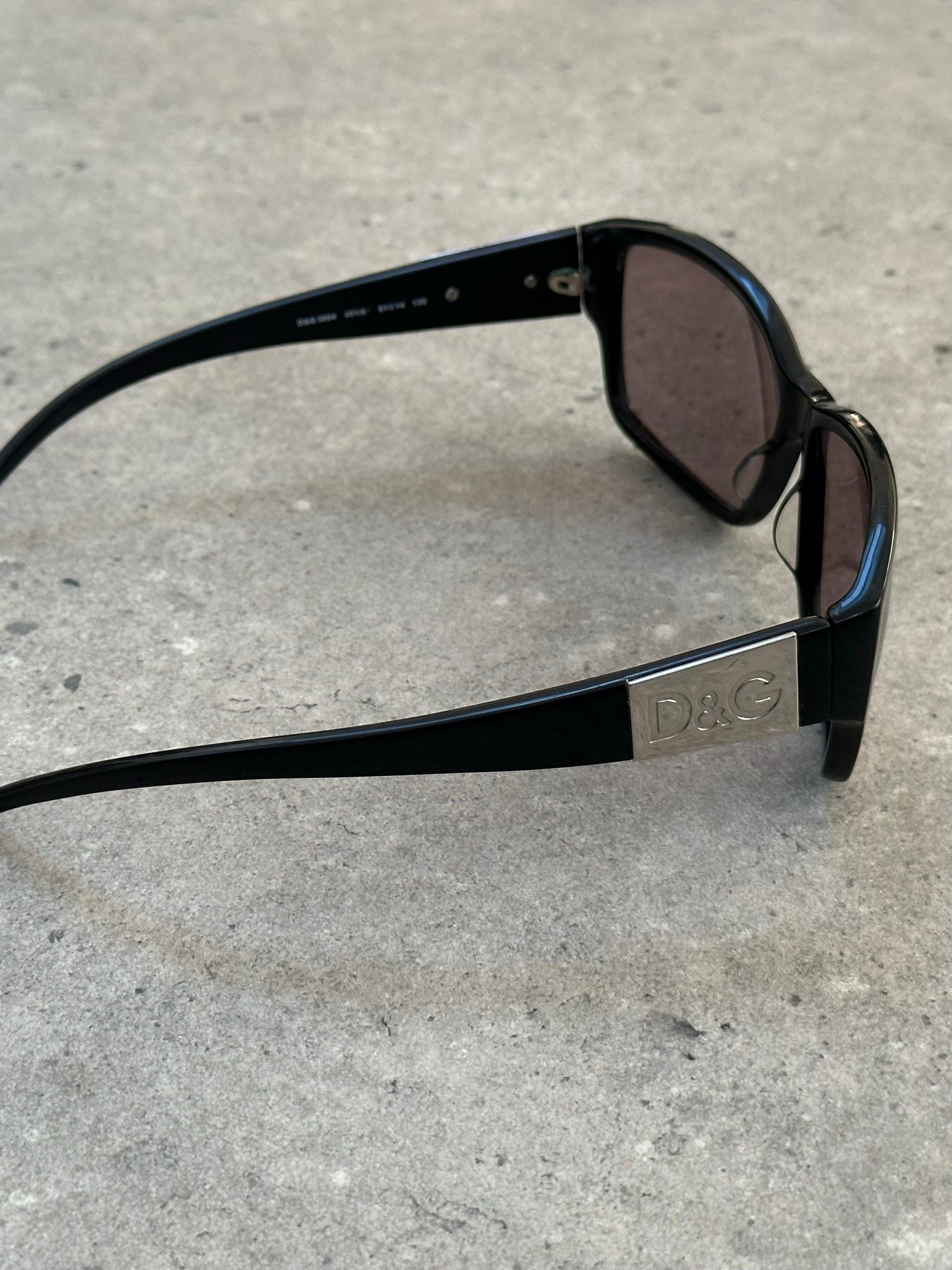 Dolce & Gabbana 2000s rectangle logo sunglasses with black frames and D&G logo on the temples.