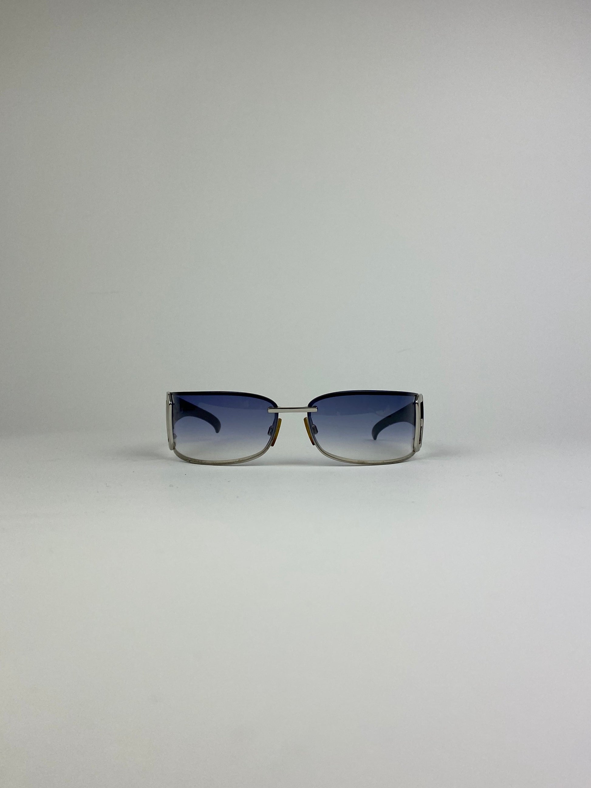 Dolce & Gabbana shield sunglasses with blue tinted lenses and sleek black frame, stylish and protective eyewear.