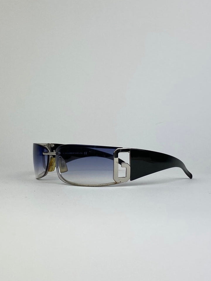 Dolce & Gabbana shield sunglasses with blue tinted lenses and black frame, stylish and modern eyewear for sun protection.