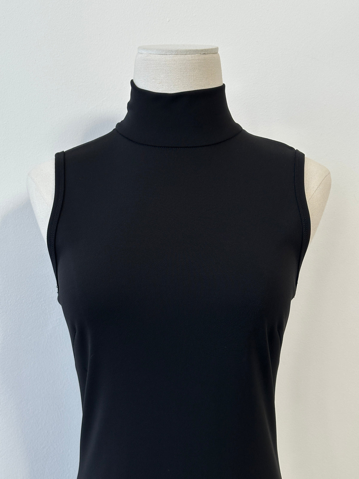 Donna Karan DKNY 1990s high neck asymmetric sleeveless dress in black, fitted style with bold design details.