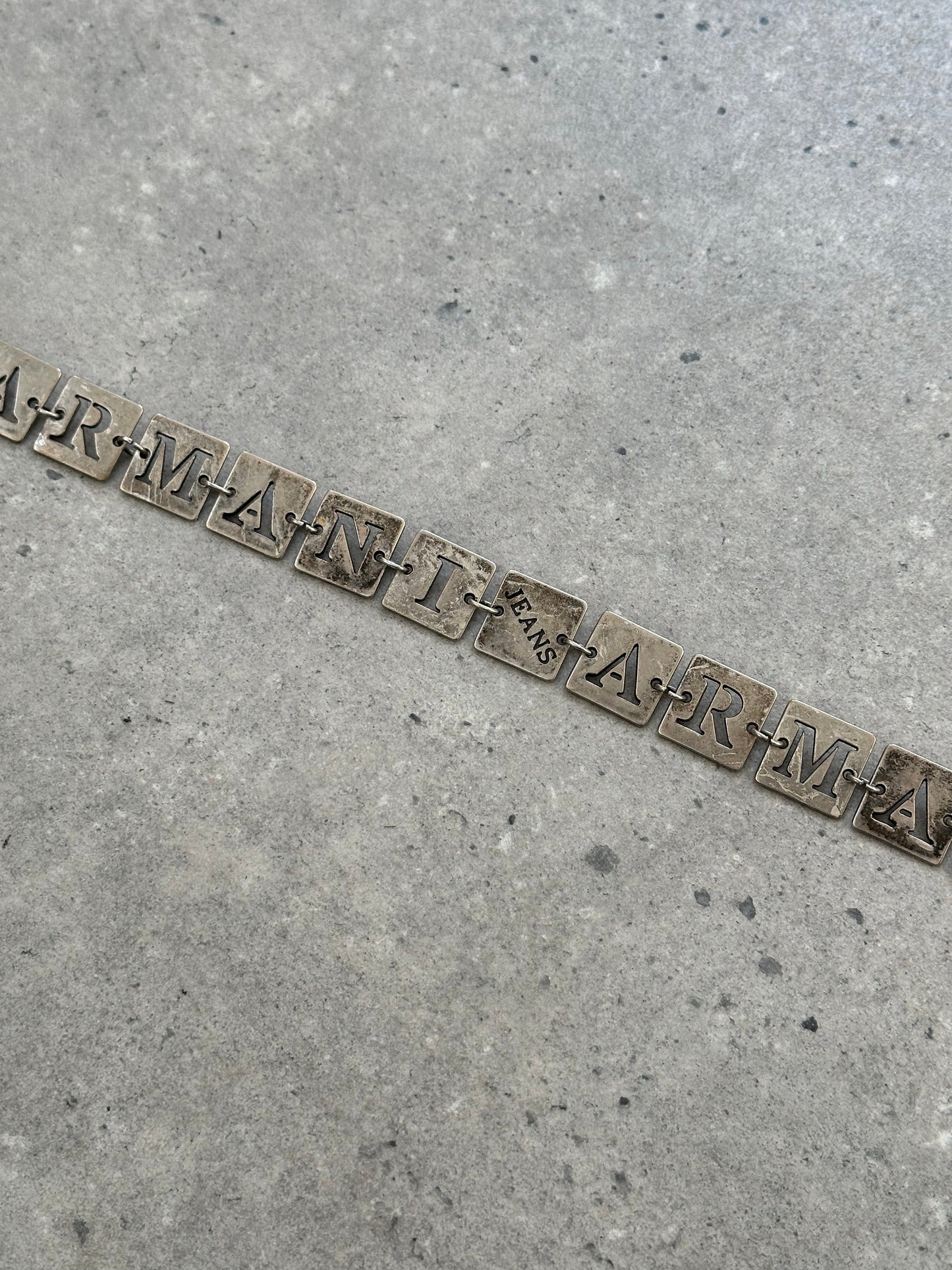 Armani Jeans 1990s monogram chain belt, one size, featuring gold-tone chain and monogram details, on a neutral background.