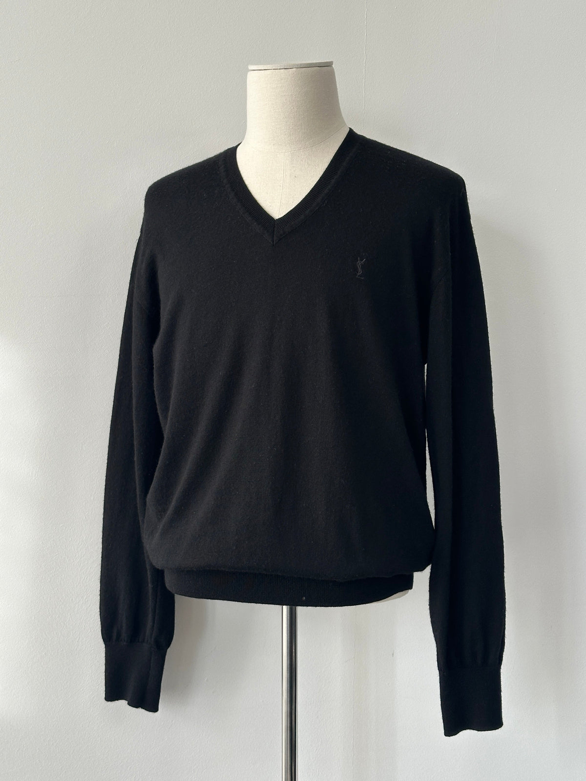 Yves Saint Laurent 1990s pure wool V-neck jumper in size M, beige color, close-up of knit fabric and classic design.