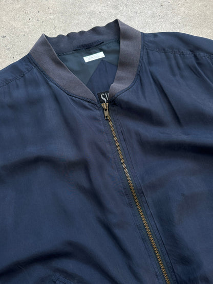 Vintage 1990s pure silk boxy bomber jacket in size L, shown in a close-up view highlighting the sleek silk fabric and classic design.