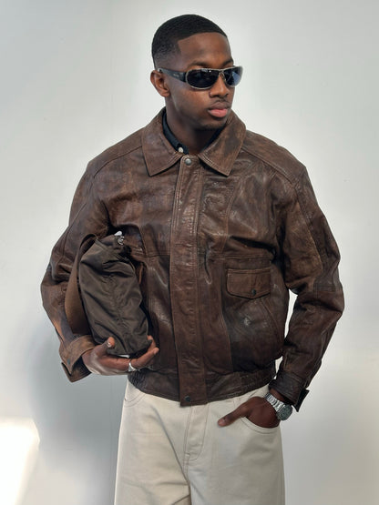 Vintage 1990s distressed leather bomber jacket, men's size M, with a rugged, worn-in look and classic style.