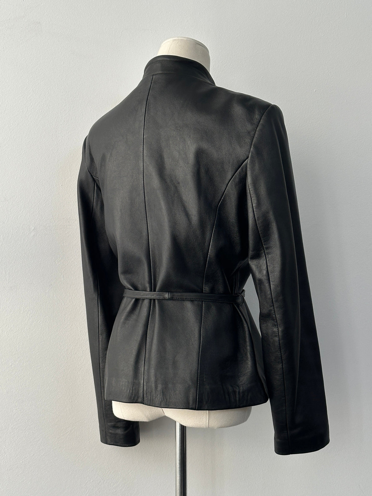 Vintage 1990s asymmetric belted leather jacket, small size, featuring classic black leather and stylish design details.