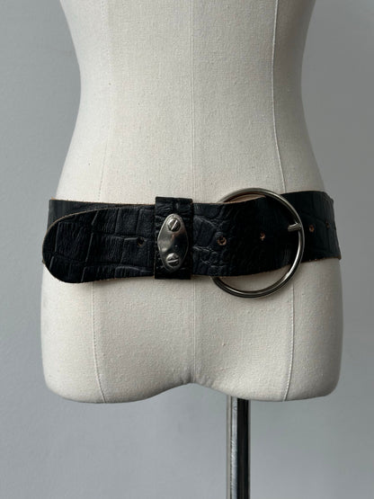 Vintage 1990s circular leather chunky belt with bold design, featuring a large round buckle and distressed leather finish.