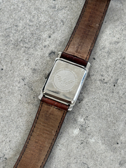 Emporio Armani 2000s leather rectangular quartz watch with a sleek black strap and minimalist dial.