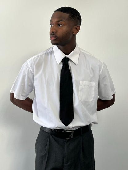 Yves Saint Laurent Pour Homme 1990s cotton short sleeve logo shirt, XXL size, white with black brand logo, laid flat.