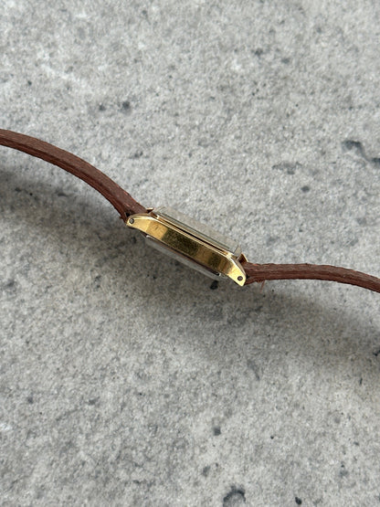 Vintage Pulsar 1980s gold-tone leather watch with a round dial and classic design, displayed on a neutral background.