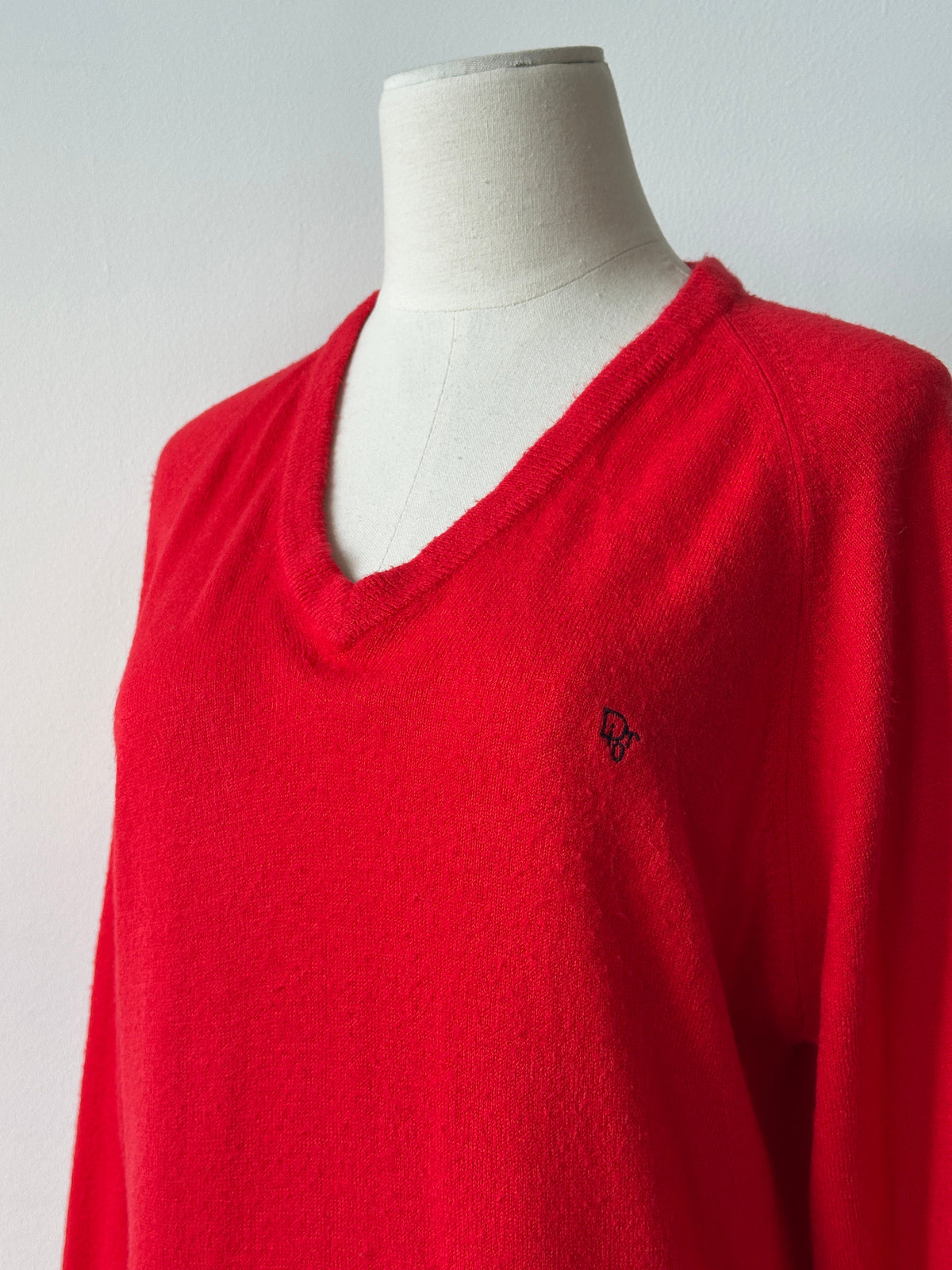 Christian Dior 1990s V-neck logo jumper in black, showing the front view with the iconic Dior logo on the chest.
