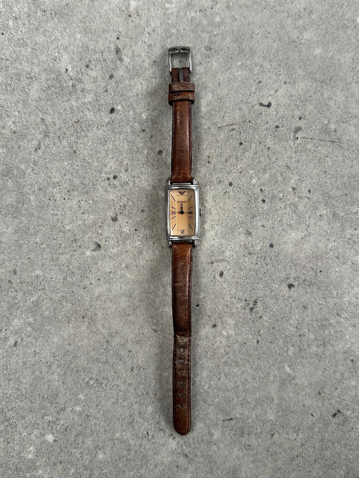 Emporio Armani 2000s leather watch with round dial, silver-tone case, and black leather strap, showcasing classic elegant design.