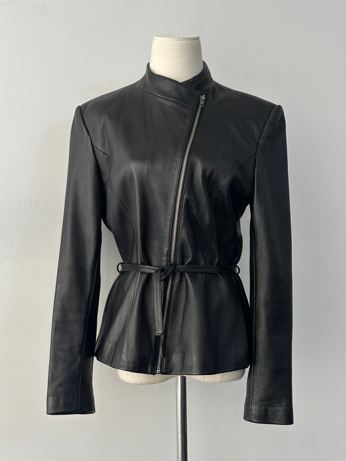 Vintage 1990s asymmetric belted leather jacket in size small, featuring classic leather texture and retro style.
