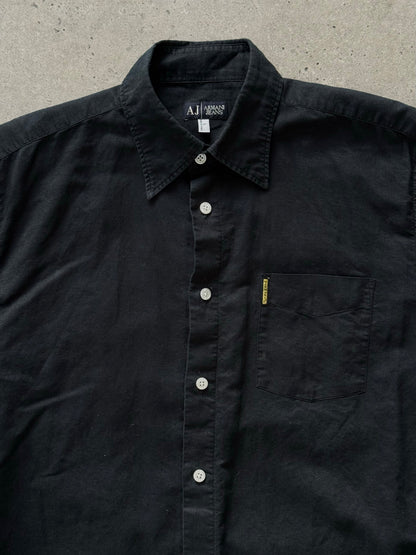 Armani Jeans 1990s pure cotton short sleeve shirt in light color, with classic collar and button closure, displayed on a hanger.