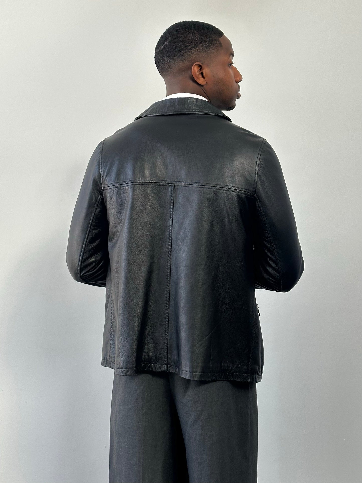 Vintage Italian 1990s leather boxy jacket in brown with a classic collar, long sleeves, and front zipper closure.