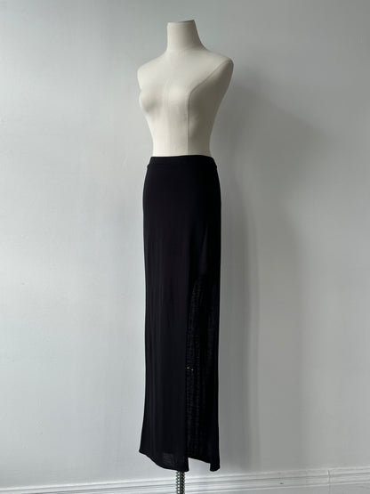 Helmut Lang 2000s side split maxi skirt in black, flowing fabric, high waist, styled with urban fashion elements.