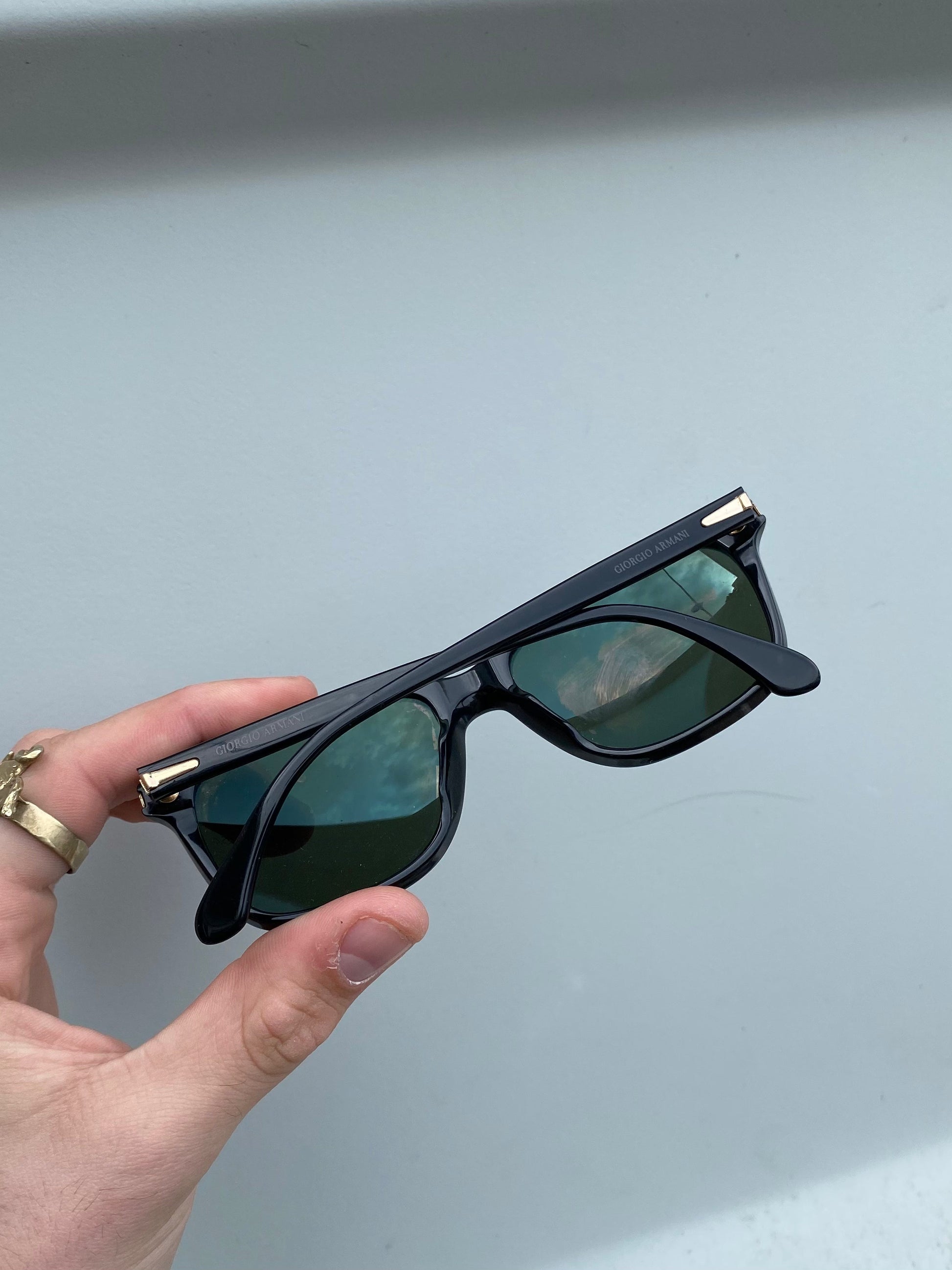 Giorgio Armani Wayfarer sunglasses with black frames and dark tinted lenses, stylish and classic eyewear for men.