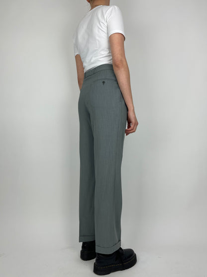 Vintage wool jumpsuit featuring a classic tailored fit and vintage style, displayed on a hanger against a neutral background.
