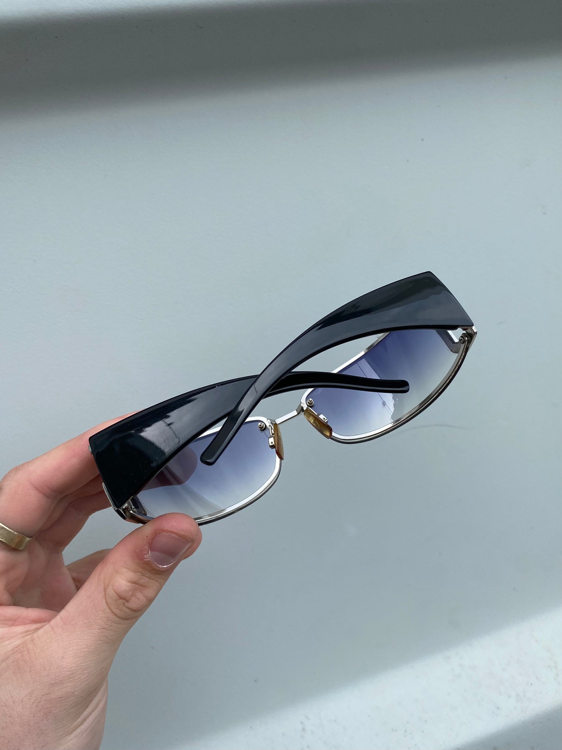 Dolce & Gabbana shield sunglasses with dark tinted lenses and sleek black frame, stylish and modern eyewear.