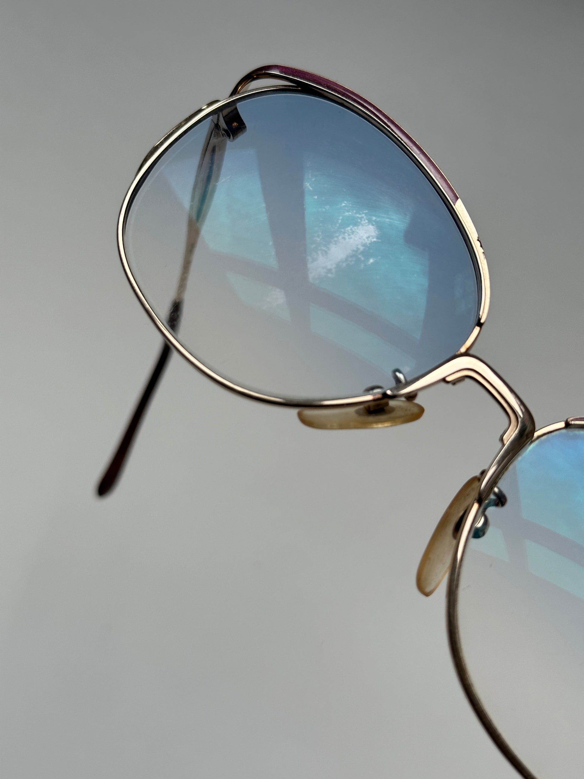 Yves Saint Laurent Paris round sunglasses with black frames and dark lenses, stylish and fashionable eyewear.