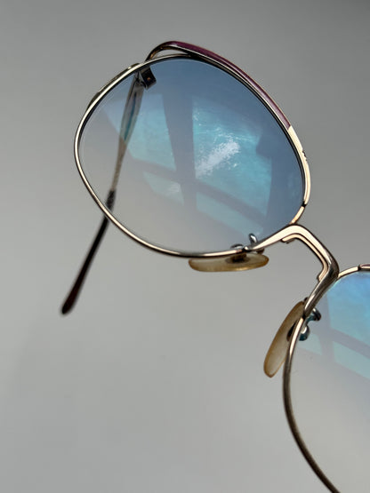 Yves Saint Laurent Paris round sunglasses with black frames and dark lenses, stylish and fashionable eyewear.