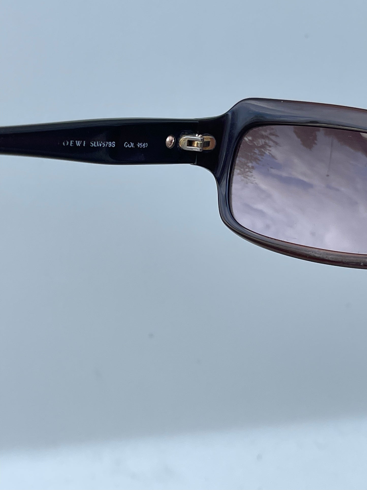 Loewe rectangle sunglasses with thick black frames and dark lenses, stylish and modern eye protection accessory.
