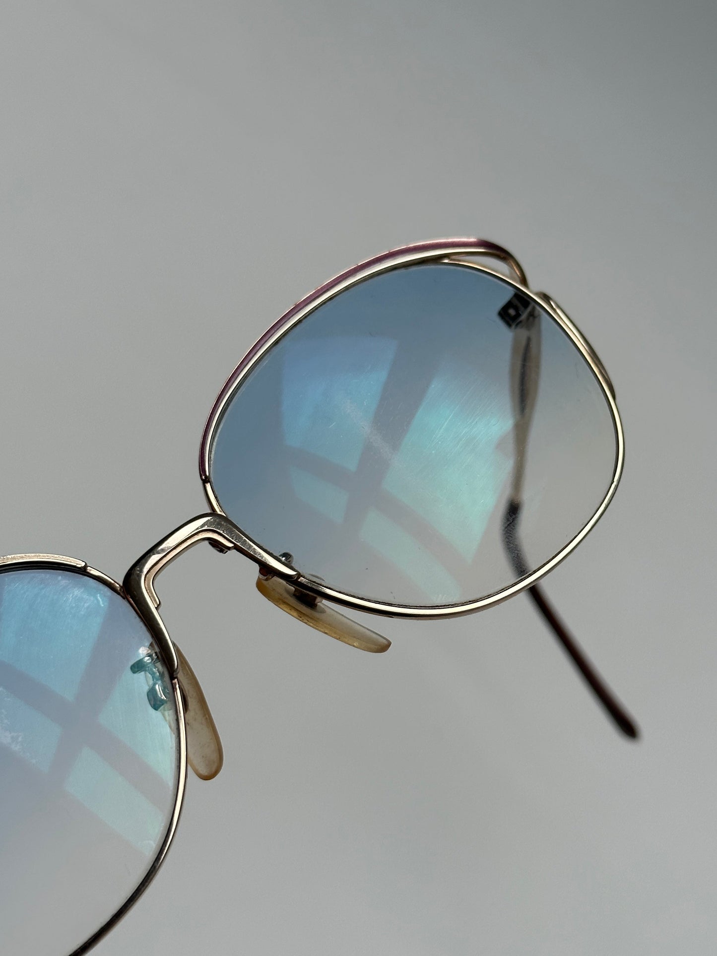 Yves Saint Laurent Paris round sunglasses with black frames and dark lenses, stylish and elegant eyewear for women.