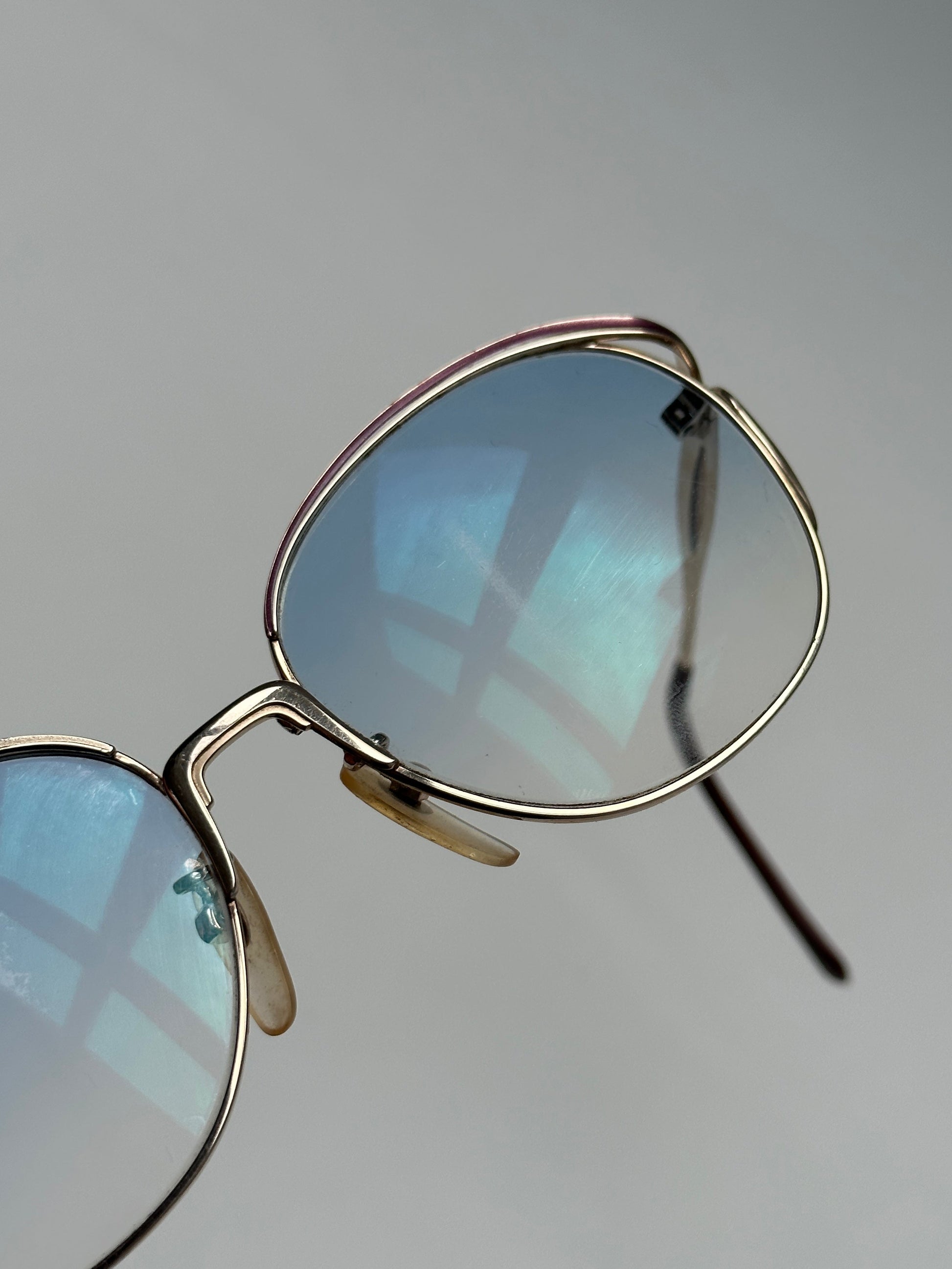 Yves Saint Laurent Paris round sunglasses with black frames and dark lenses, stylish and elegant eyewear for women.