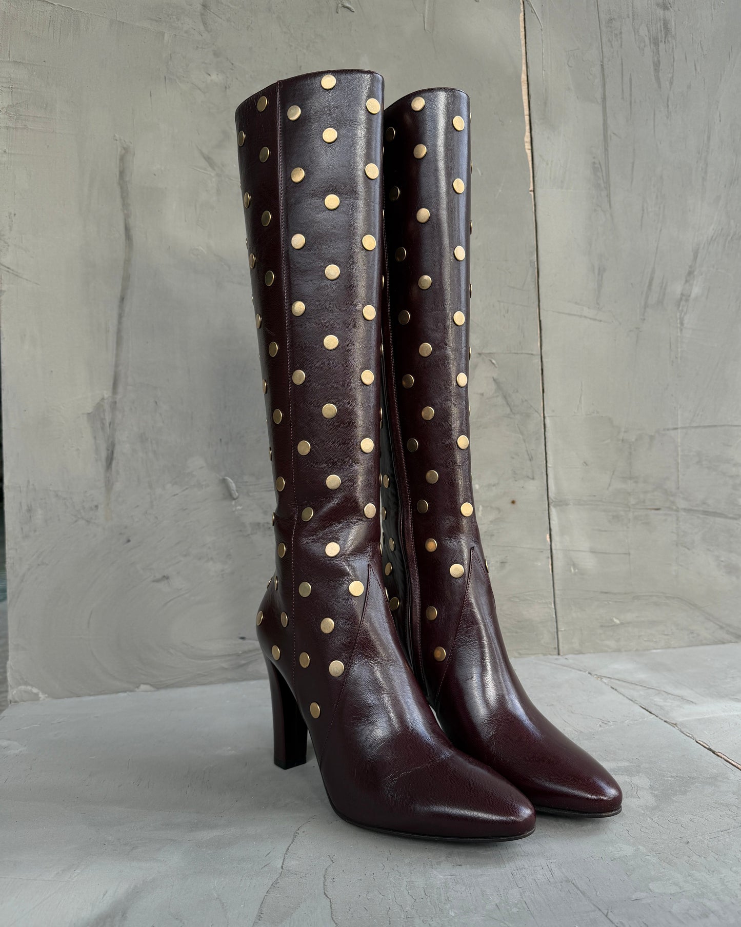 Saint Laurent Studded Leather Heeled Boots – EU 40-on a concrete background