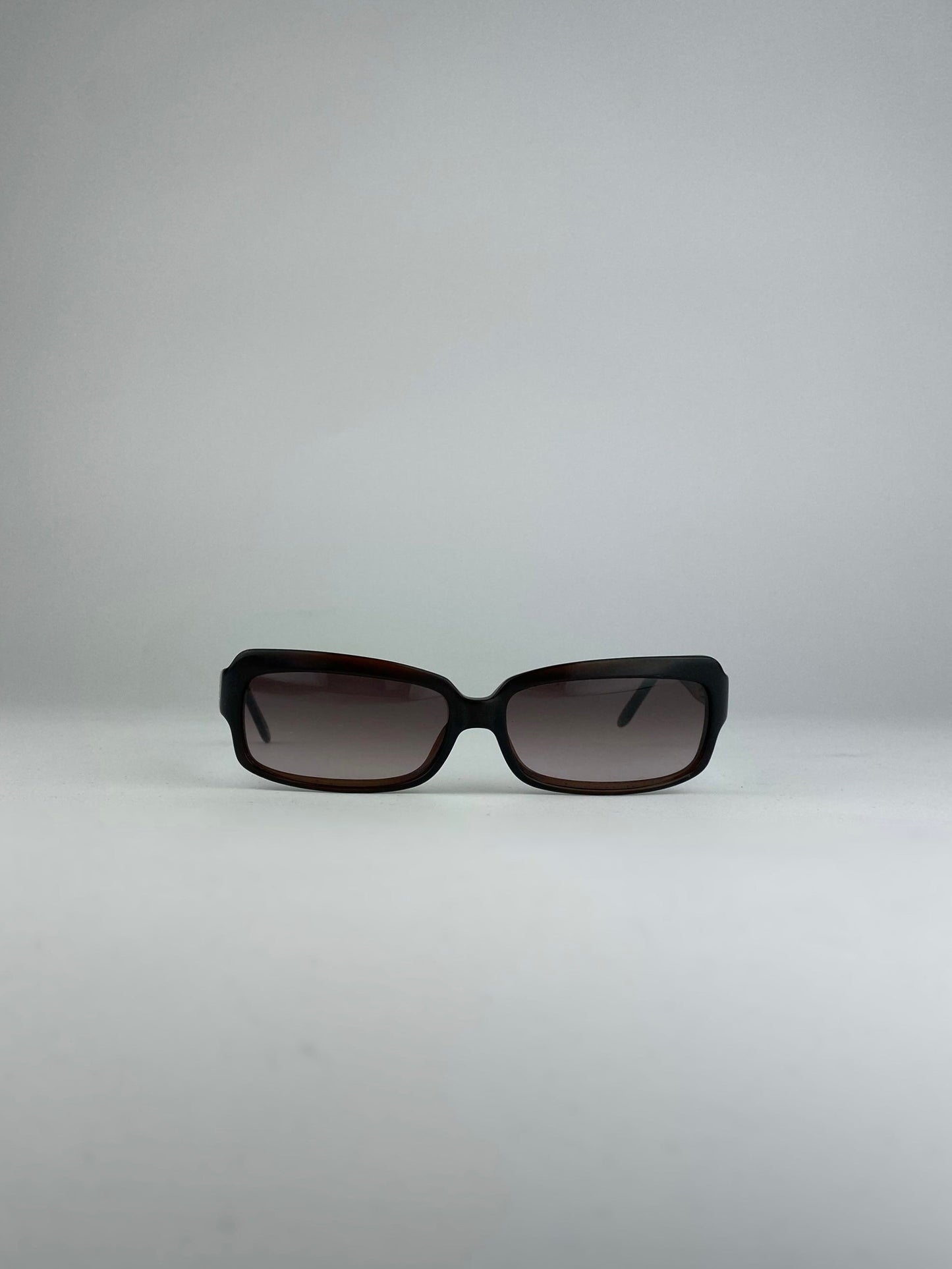Loewe rectangle sunglasses with brown frames and dark lenses, stylish eyewear for sun protection and fashion.