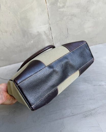 Prada Canvas and Leather Tote Bag-on a concrete background