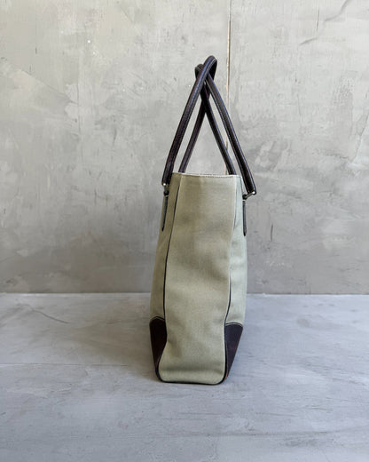 Prada Canvas and Leather Tote Bag-on a concrete background