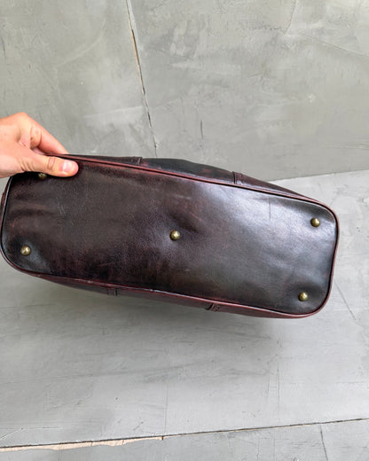 Yves Saint Laurent Leather Muse Bag-on a concrete background